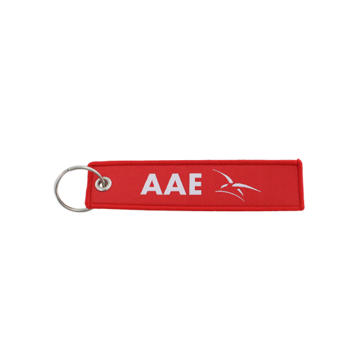 Porte clé en tissu rouge, avec le logo de l'armée de l'air et de l'espace en blanc.