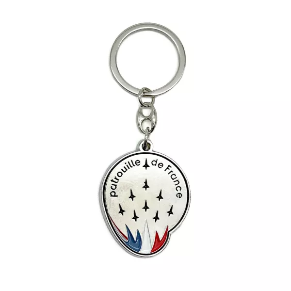 Fond métallisé et inscriptions noires tricolores. Anneau en métal.