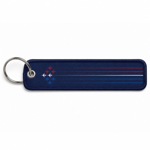 Porte clé en metal avec flamme en tissu de coloris bleu marine, et inscription blanche "Patrouille de France"