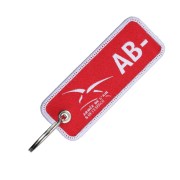 Porte-clés en tissu rouge tissé recto/verso en blanc avec le logo de l'armée de l'Air & de l'Espace et le groupe sanguin : AB-