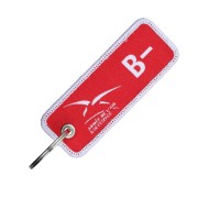 Porte-clés en tissu rouge tissé recto/verso en blanc avec le logo de l'Armée de l'Air & de l'Espace et le groupe sanguin : B-