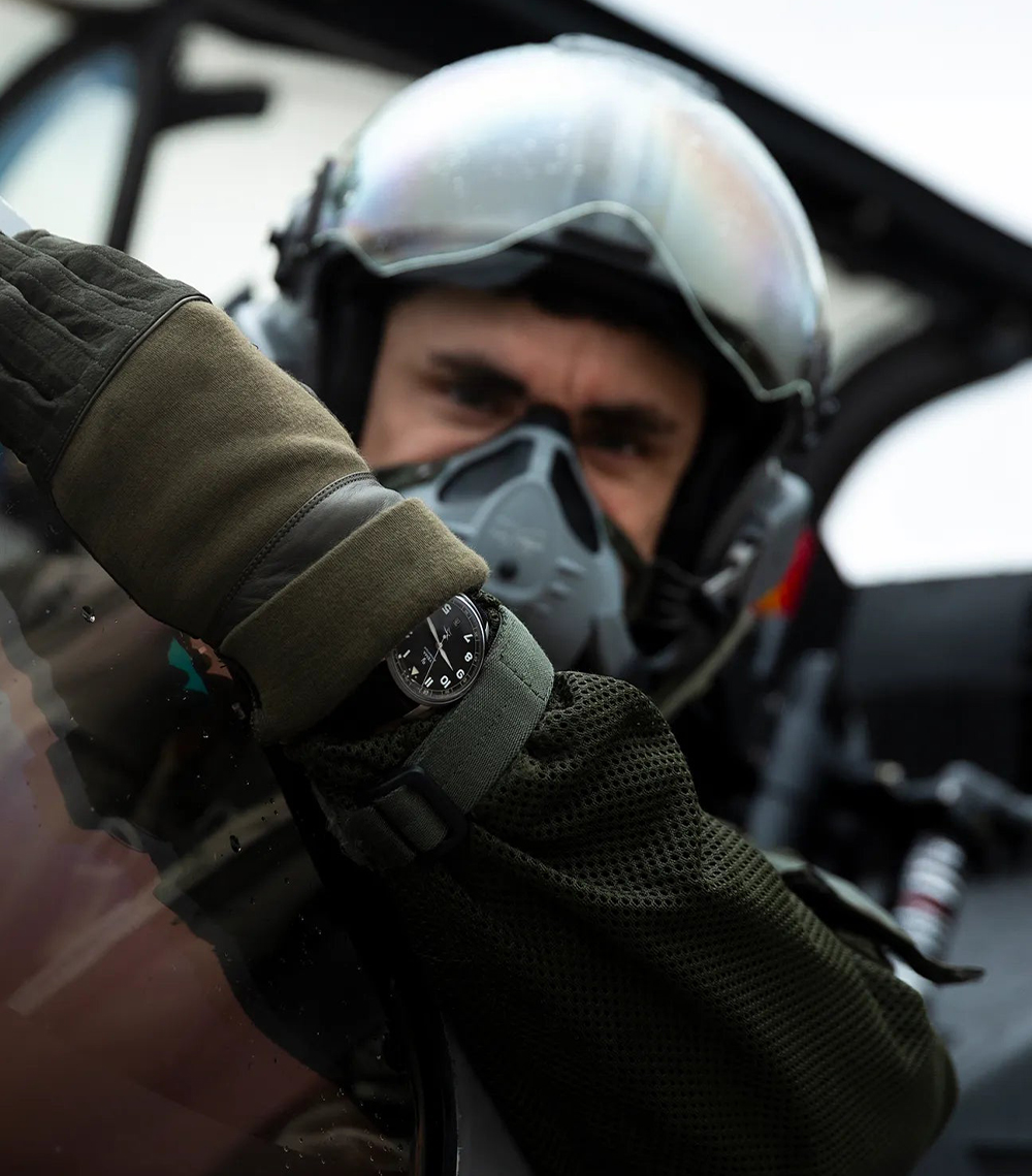 Montre portée au poignet par un pilote de l'armée de l'air et de l'espace, installé dans le cockpit de son avion.